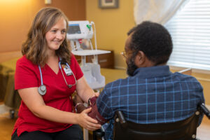 A nurse assisting a resident at Whitney Oaks