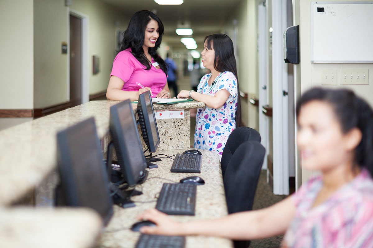 Two nurses talking at Whitney Oaks