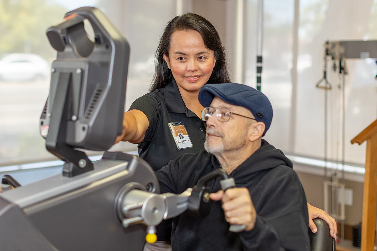 A therapist helping a resident at Whitney Oaks