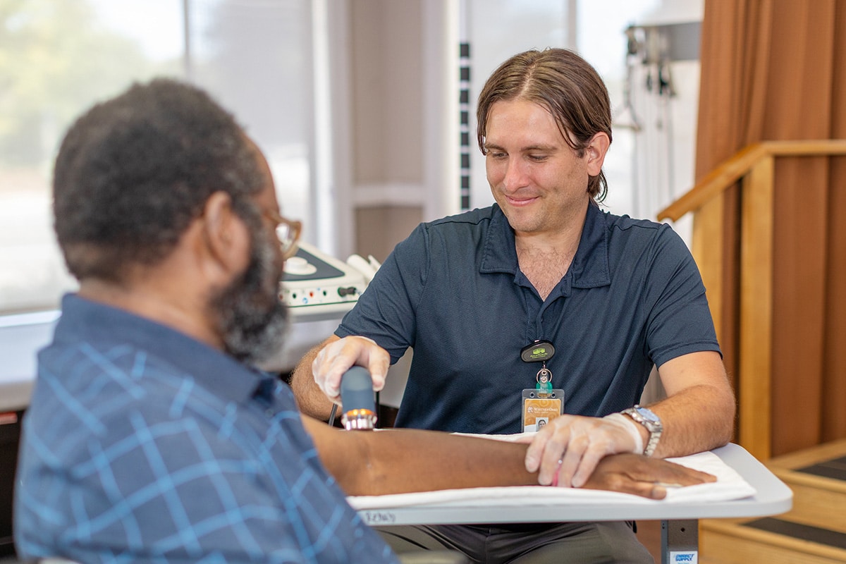A therapist helping a resident at Whitney Oaks