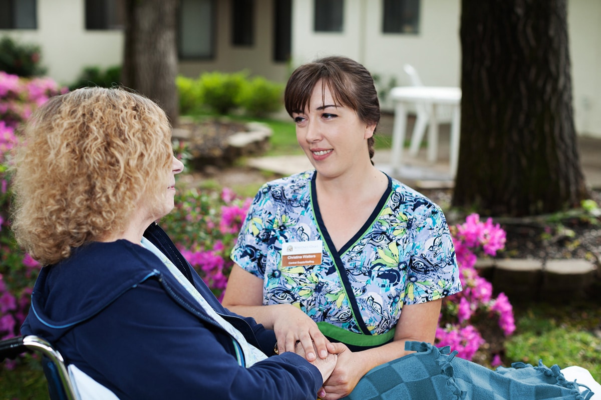 A nurse with a resident of Whitney Oaks