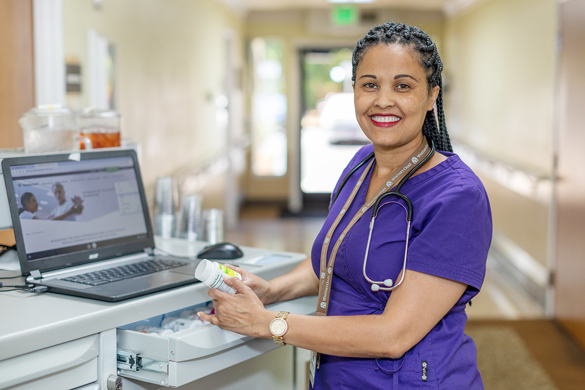 A nurse at the computer at Whitney Oaks